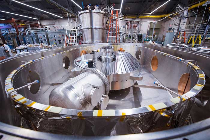 a gigantic magnet inside a cryostat container perhaps 15 feet long, in a huge, busy lab